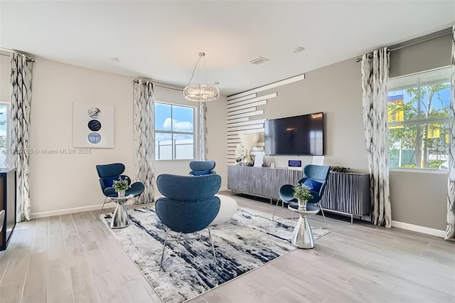 living room featuring plenty of natural light and light hardwood / wood-style flooring