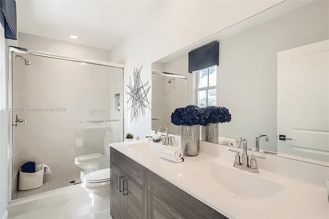 bathroom with vanity, toilet, tile patterned floors, and a shower with shower door