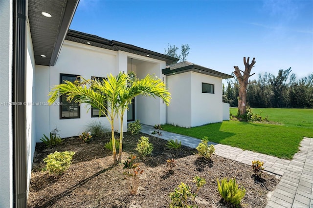 view of side of home with a lawn