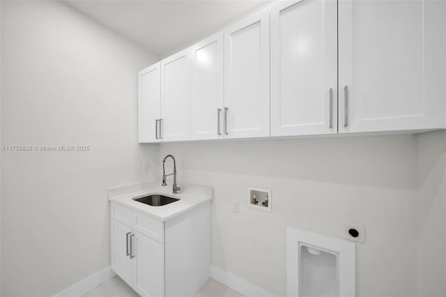 laundry area featuring sink, hookup for an electric dryer, hookup for a washing machine, light tile patterned floors, and cabinets