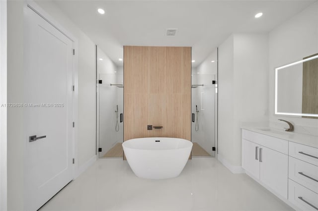 bathroom featuring vanity, independent shower and bath, and tile patterned flooring