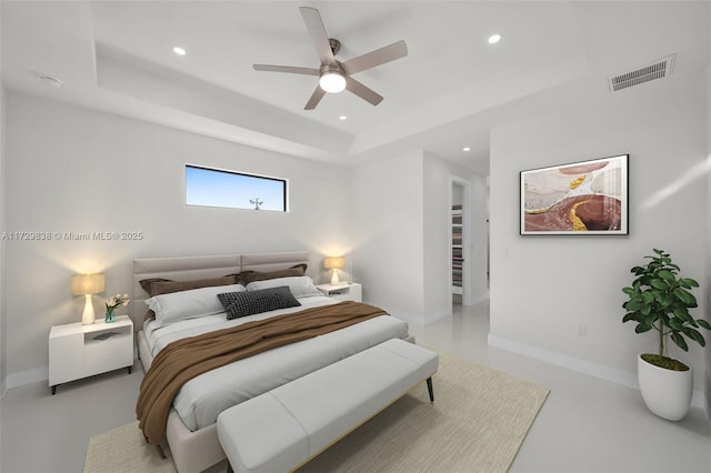 bedroom featuring ceiling fan and a raised ceiling