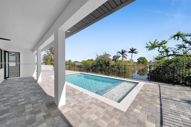 view of pool featuring a water view and a patio