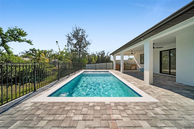 view of swimming pool with ceiling fan and a patio