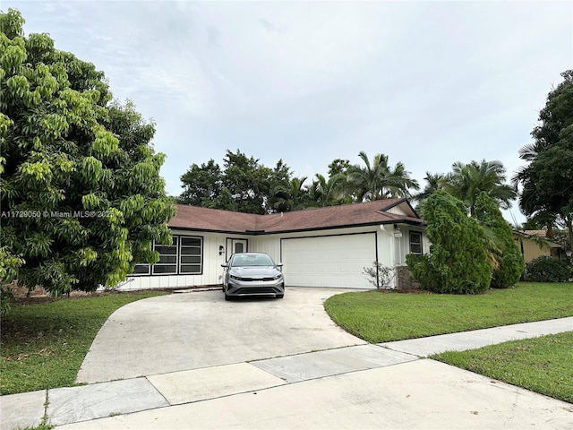 ranch-style house with a garage and a front lawn