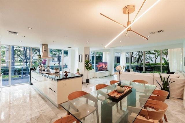 dining area featuring sink and expansive windows