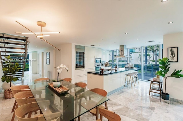 dining room with sink and floor to ceiling windows