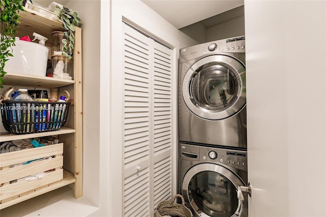 clothes washing area featuring stacked washer and dryer