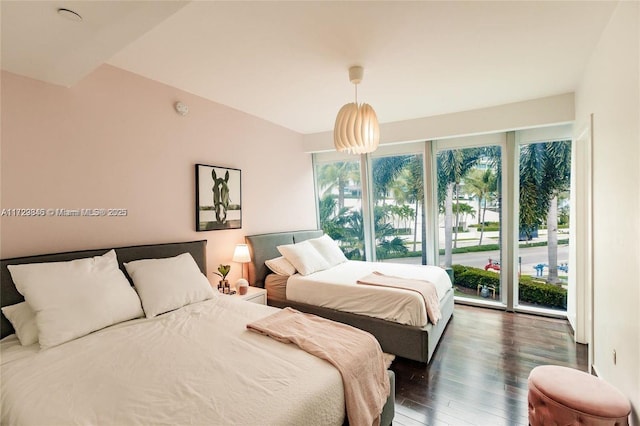 bedroom with dark wood-type flooring and access to exterior