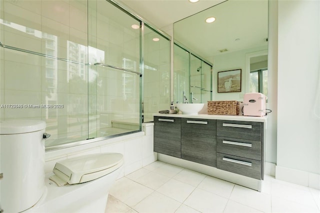 bathroom featuring vanity, toilet, a shower with door, and tile patterned flooring