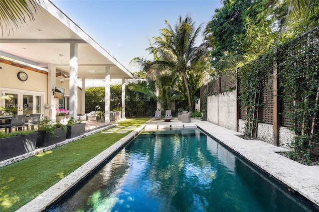 view of pool with a patio area and french doors