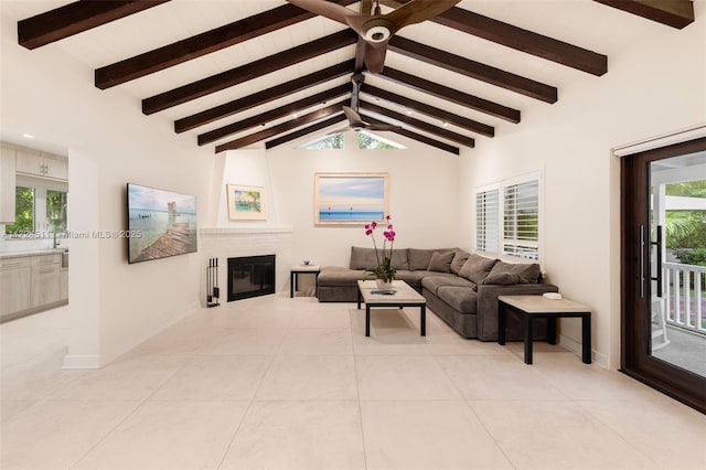 tiled living room featuring a fireplace and vaulted ceiling with beams