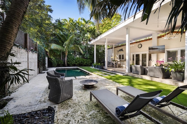 view of swimming pool with outdoor lounge area, french doors, and a patio