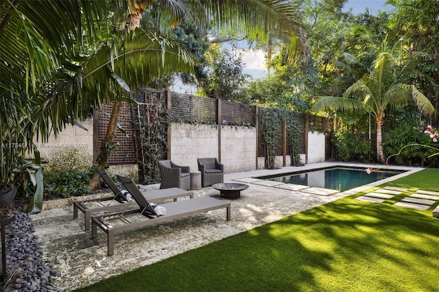 view of pool featuring a patio area and a yard