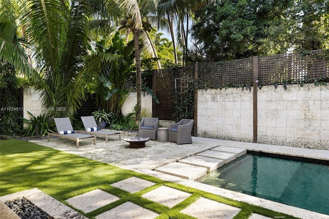 view of pool featuring a patio and an outdoor fire pit