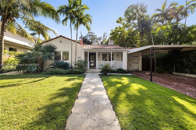 view of front of property with a front yard and a carport