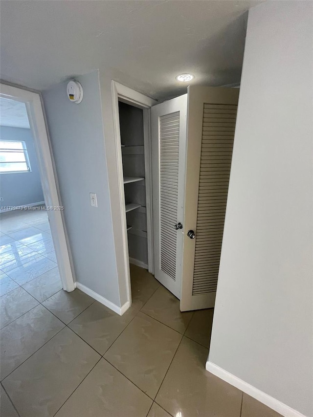 corridor featuring tile patterned flooring