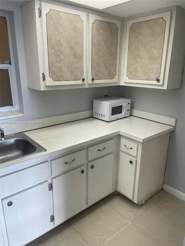 kitchen with sink and light tile patterned floors