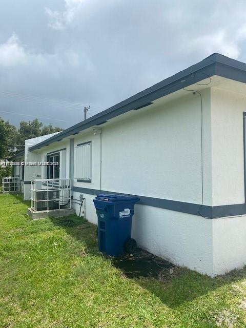 view of side of home with a lawn