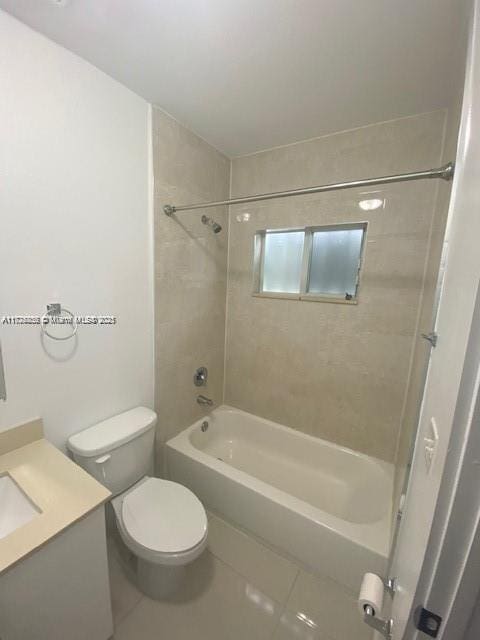 full bathroom with vanity, toilet, tiled shower / bath, and tile patterned flooring