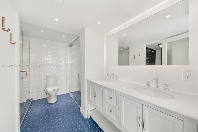 bathroom with toilet, a shower with shower door, tile patterned floors, and vanity