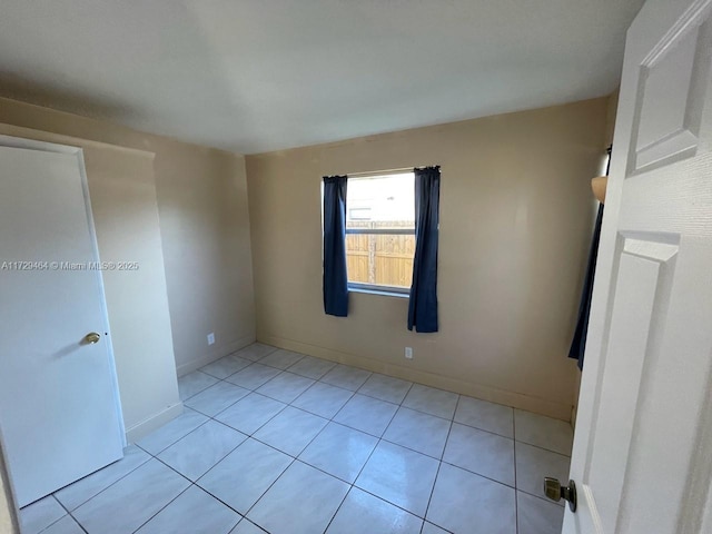 unfurnished room with light tile patterned floors