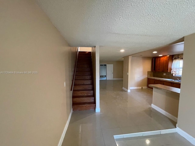 interior space featuring tile patterned flooring and a textured ceiling