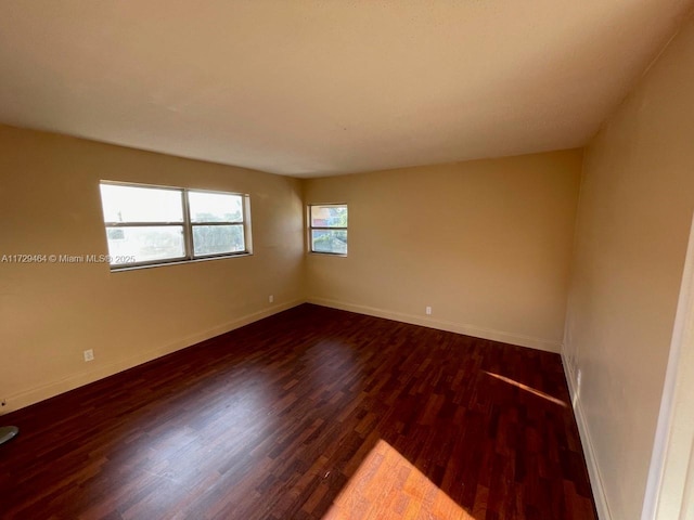 spare room featuring dark hardwood / wood-style flooring