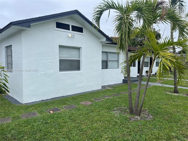 view of home's exterior with a lawn