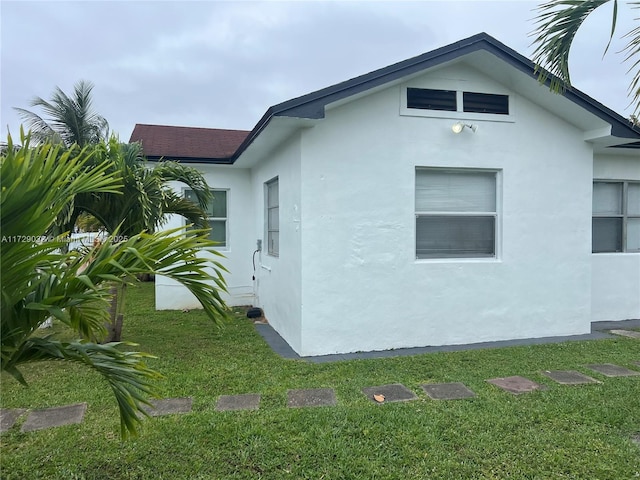 view of property exterior with a lawn