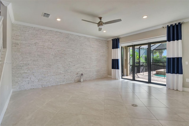 spare room featuring ceiling fan, ornamental molding, and light tile patterned floors