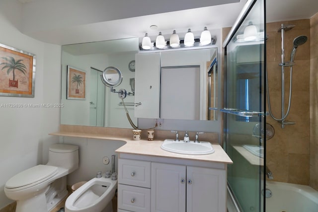 full bathroom with vanity, a bidet, shower / bath combination with glass door, and toilet