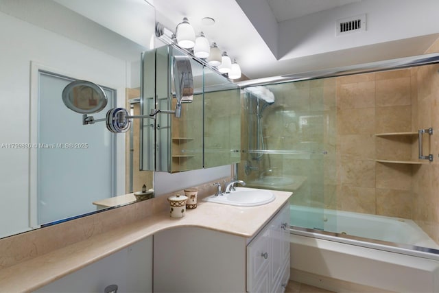 bathroom featuring enclosed tub / shower combo and vanity