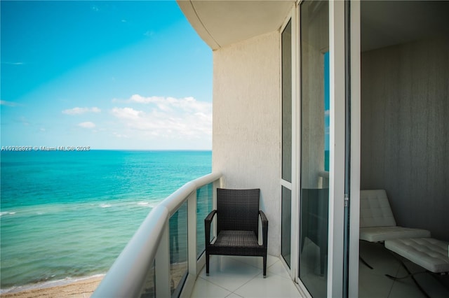 balcony featuring a water view and a view of the beach