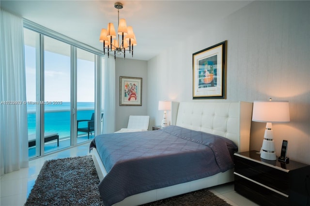 bedroom with light tile patterned floors, a water view, an inviting chandelier, floor to ceiling windows, and access to exterior