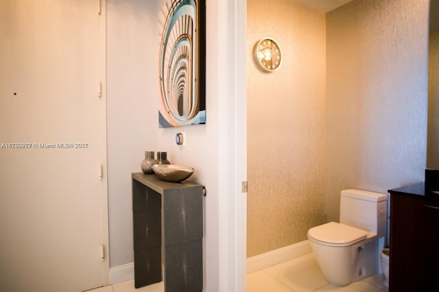 bathroom featuring toilet, vanity, and tile patterned flooring