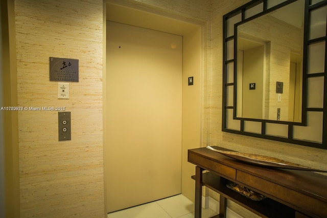 bathroom featuring elevator and tile patterned flooring