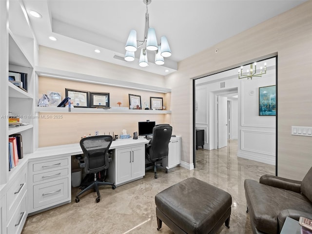 home office with an inviting chandelier and built in shelves