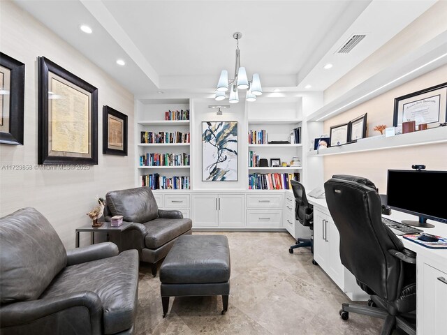 office space with a raised ceiling, a notable chandelier, and built in shelves