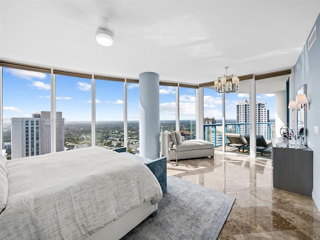 bedroom with a chandelier and a wall of windows