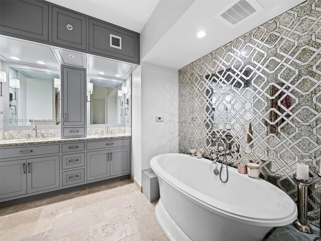 bathroom featuring vanity and a washtub