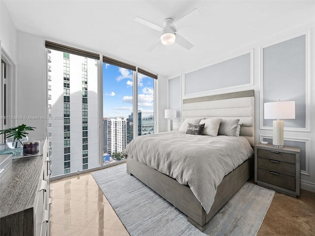 bedroom featuring floor to ceiling windows, access to exterior, and ceiling fan