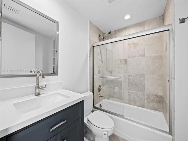 full bathroom with vanity, toilet, and combined bath / shower with glass door