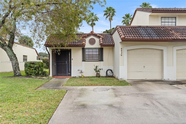 mediterranean / spanish house featuring a garage and a front lawn