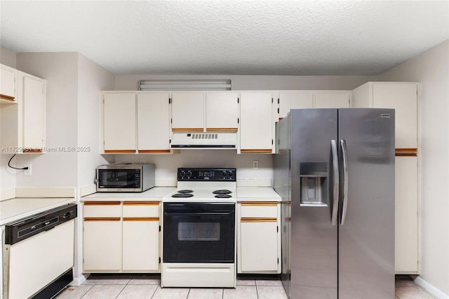 kitchen with white cabinetry, light tile patterned floors, stainless steel appliances, and a textured ceiling