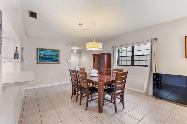 tiled dining area with lofted ceiling