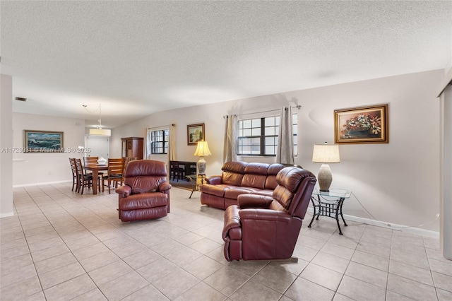 tiled living room with a textured ceiling and lofted ceiling