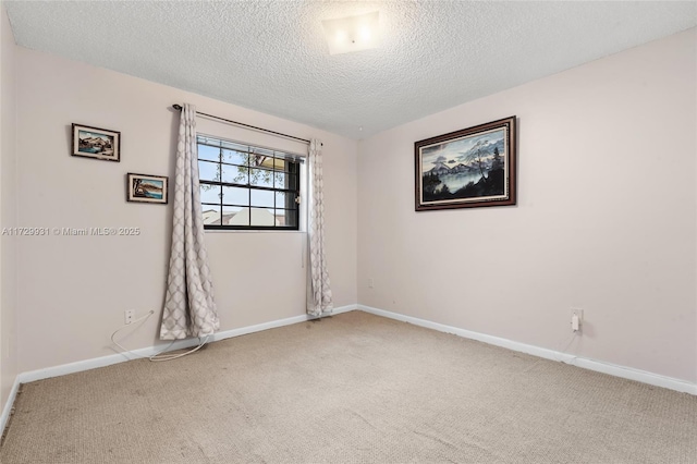 empty room with a textured ceiling and carpet floors