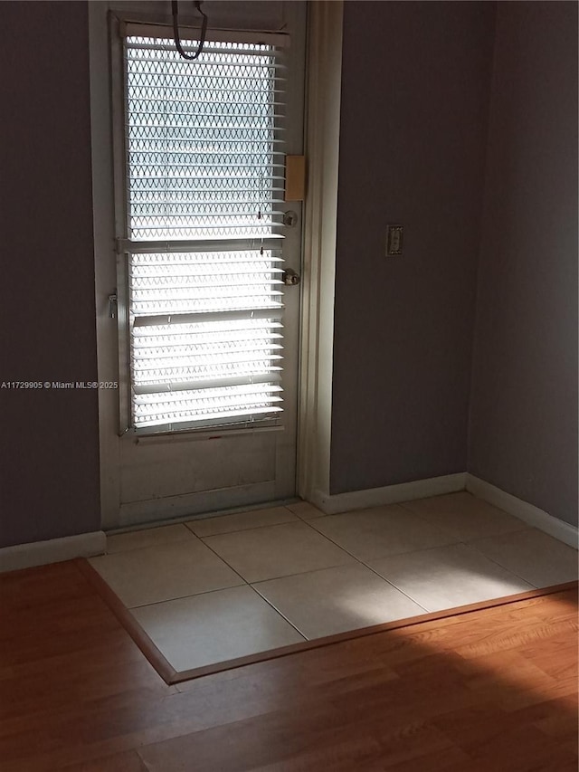 doorway with tile patterned floors