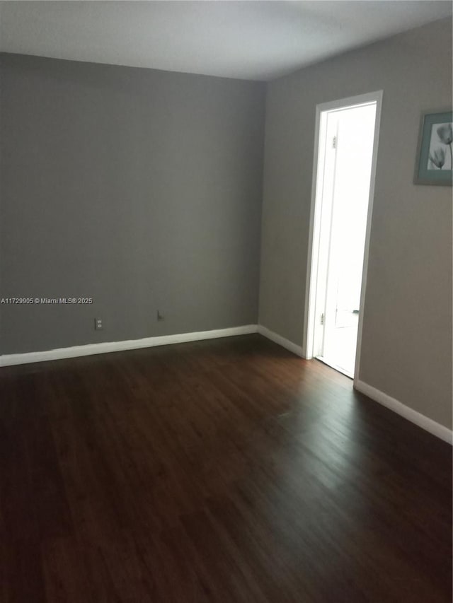 empty room featuring dark wood-type flooring